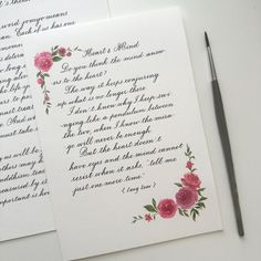 two handwritten letters with flowers on them next to a pen and ink rollers