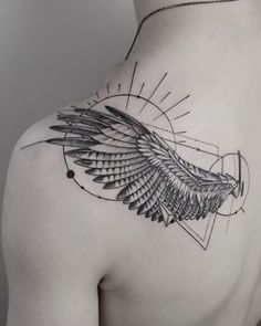 a woman's back with an eagle tattoo on it