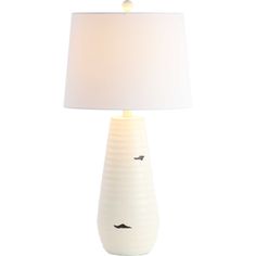 a white table lamp with a bird design on the base and a light shade over it