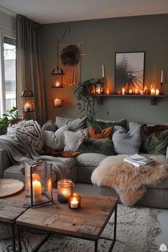 a living room filled with lots of furniture and candles on top of the couches