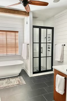 a bathroom with a tub, sink and shower stall in the middle of the room