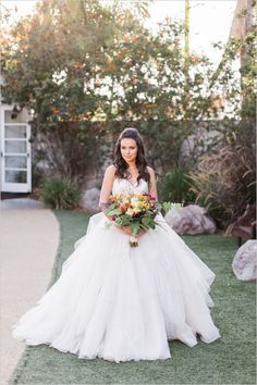 a woman in a wedding dress holding a bouquet