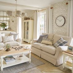 a living room filled with furniture and a clock on the wall