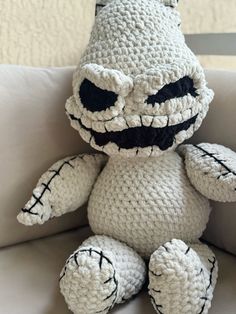 a crocheted stuffed animal sitting on top of a couch