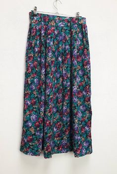 "a vintage green and purple floral high-waisted long skirt ✿ IMPORTANT INFORMATION: * excellent vintage condition * material: 100% rayon * size: extra-small - please check exact measurements below (they're there for your benefit!) * garment care: machine washable * made in the u.s.a. ✿ MEASUREMENTS (taken while item is lying flat, some measurements will need to be doubled): * length: 31\" (79cm) * waist: 12.5\" (32cm) * hips: 29\" (74cm) ✿ free UK shipping on orders over £100 with code STRAWBERR Green Floral Print Flowy Skirt, Green Flared Maxi Skirt With Floral Print, Bohemian Purple Floral Print Bottoms, Bohemian Purple Bottoms With Floral Print, Bohemian Purple Floral Print Skirt, Green Flared Skirt With Floral Print, Vintage Purple Lined Skirt, Vintage Green Tiered Skirt, Green Floral Print Relaxed Skirt