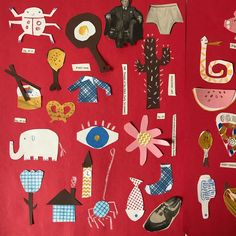 paper cut outs are arranged on a red surface with various objects in the shape of people and animals