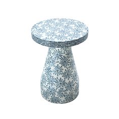 a small blue and white vase sitting on top of a table