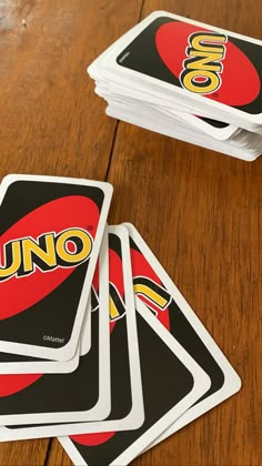 four uno uno cards sitting on top of a wooden table