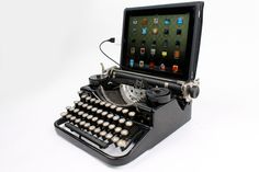 an old - fashioned typewriter with a tablet mounted on it's side, sitting in front of a white background