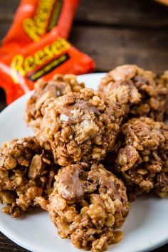 no bake cookies on a white plate next to a bag of reeses candy