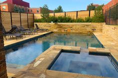 an outdoor swimming pool with chairs around it