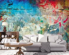 a living room filled with furniture and walls covered in colorful graffiti paint on the wall