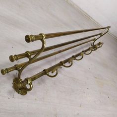 four brass coat rack with five hooks on each side