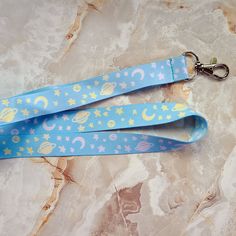 "The perfect lanyard/badge holder for fans of pastel colors and celestial themes. The image is dye-sublimated onto the fabric on both sides and is fade resistant with a durable lobster claw clasp at the end for all your attaching needs! It is about 18\" long folded (36\" looped around) excluding the clasp. It'd be great adorning your keys, attached to an ID card, or as a badge lanyard for a convention! --- Lanyards offer the ultimate convenience! Keep your valuables close at hand such as wallet/ Company Card, Lanyard Badge Holder, Nurse Lanyard, Lanyard Teacher, Bus Pass, Badge Lanyard, Teacher Lanyard, Phone Camera, Wallet Pouch