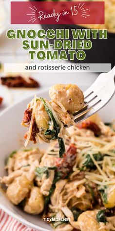 a white plate topped with pasta and spinach covered in grated cheese next to a fork