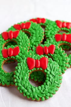 green and red decorated cookies with bows on them