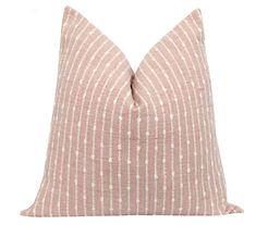 a pink and white striped pillow on a white background