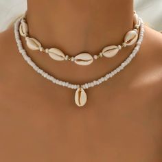 Elevate your style with our Trendy Geometric Shell Necklace, a perfect blend of modern design and natural elements. At 43cm in length, this necklace features bold geometric shapes paired with delicate shells, creating a unique and eye-catching piece. Its combination of sleek lines and organic textures makes it versatile for both casual and formal looks. Whether layered or worn alone, this trendy necklace adds a chic, beach-inspired touch to any outfit. Ideal for those who love modern elegance wi Summer Beach Jewelry, Choker Pendant, Rice Bead, Neck Choker, Beaded Pendant Necklace, Beaded Choker Necklace, Themed Jewelry, Shell Pendant, Shell Necklaces