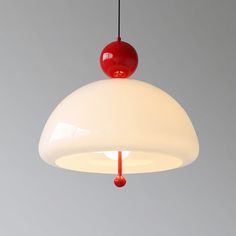 a red and white light hanging from a ceiling