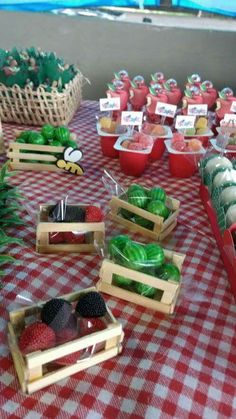 a table topped with lots of different types of fruits and veggies on wooden trays