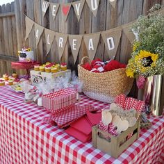 a red and white checkered table cloth with cupcakes on it