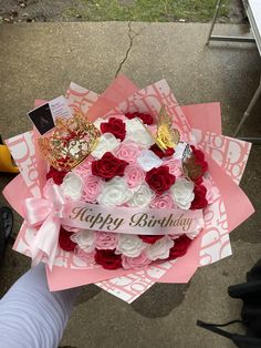 someone is holding a birthday card with roses on it