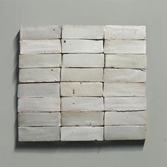 several white tiles stacked on top of each other in the shape of rectangles