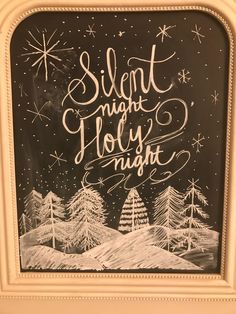 a chalkboard with the words silent night holly night written in white lettering on it