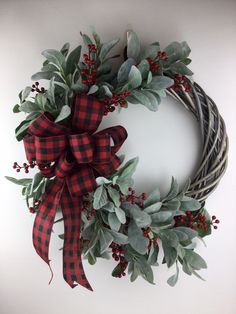 a christmas wreath with red berries and green leaves