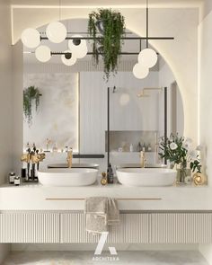 a bathroom with two sinks, mirrors and plants on the wall above them in front of a mirror