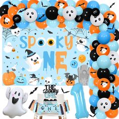 an assortment of balloons and decorations for a spooky one birthday party