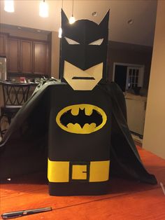 a cardboard batman costume sitting on top of a table