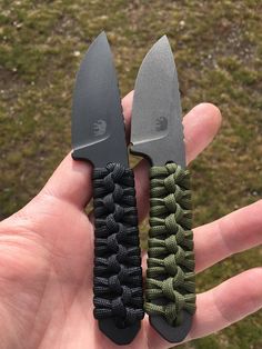 someone holding two knives in their hand with green and black paracortes attached to them