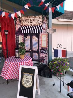 an outside cafe with tables and signs on the sidewalk