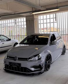 two cars parked in a parking garage next to each other