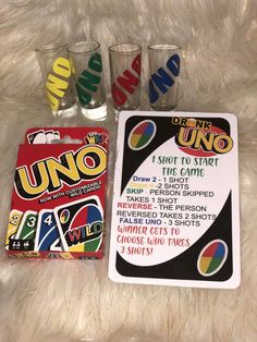 uno uno cards and shot glasses on a fur surface with the instructions for how to use them