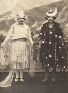 two women standing next to each other in front of a wall with stars on it