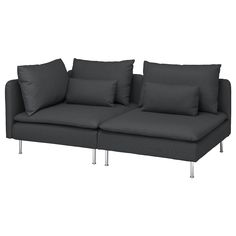 a gray couch with pillows on top of it and some metal legs in front of it