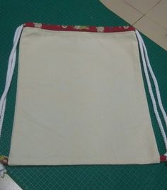 a white bag sitting on top of a green mat