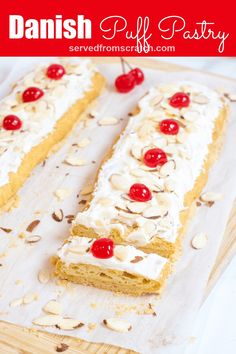 a cake with white frosting and cherries on top