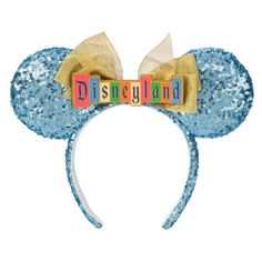 a mickey mouse ears headband with the word disneyland spelled on it