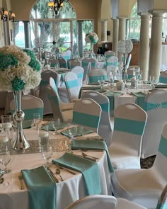 the tables are set with silverware and blue napkins for an elegant wedding reception