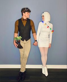 a man and woman dressed in costumes standing next to each other