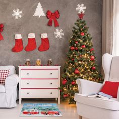 a living room decorated for christmas with stockings on the wall