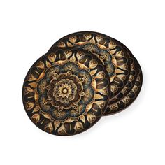 three black and gold decorative plates on a white background, each with an intricate design