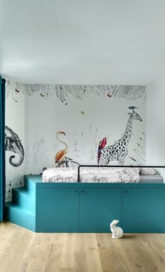 a child's bedroom with an animal themed wallpaper on the walls and floor