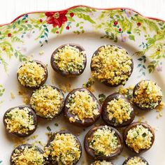 chocolate covered desserts with sprinkles on a white and floral plate, ready to be eaten