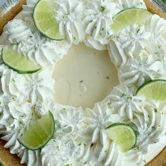 a pie with limes and whipped cream on top