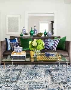 a living room filled with lots of furniture and flowers on top of a coffee table