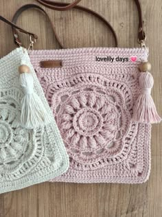 two crocheted purses with tasselled handles, one in pink and the other in white